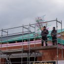 Feuerwehrleute stehen auf dem Gerüst des neuen Feuerwehrgerätehauses