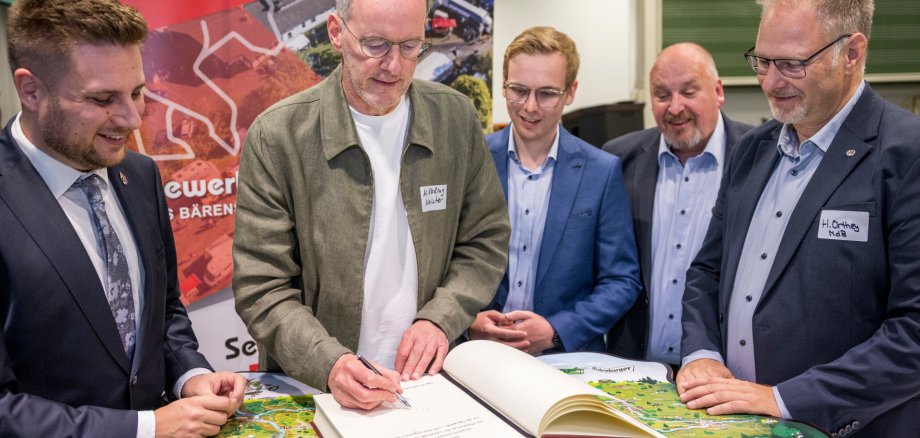 Eintrag in das Goldene Buch der Verbandsgemeinde Bad Marienberg. V.l.n.r. Bürgermeister Marvin Kraus, Wirtschaftsminister Michael Ebling, Vorsitzender des Gewerbevereins Hof e.V. Robert Fischbach, Ortsbürgermeister Jochen Becker, Harald Orthey MdB